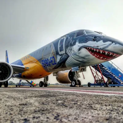 An airplane with a shark design on it